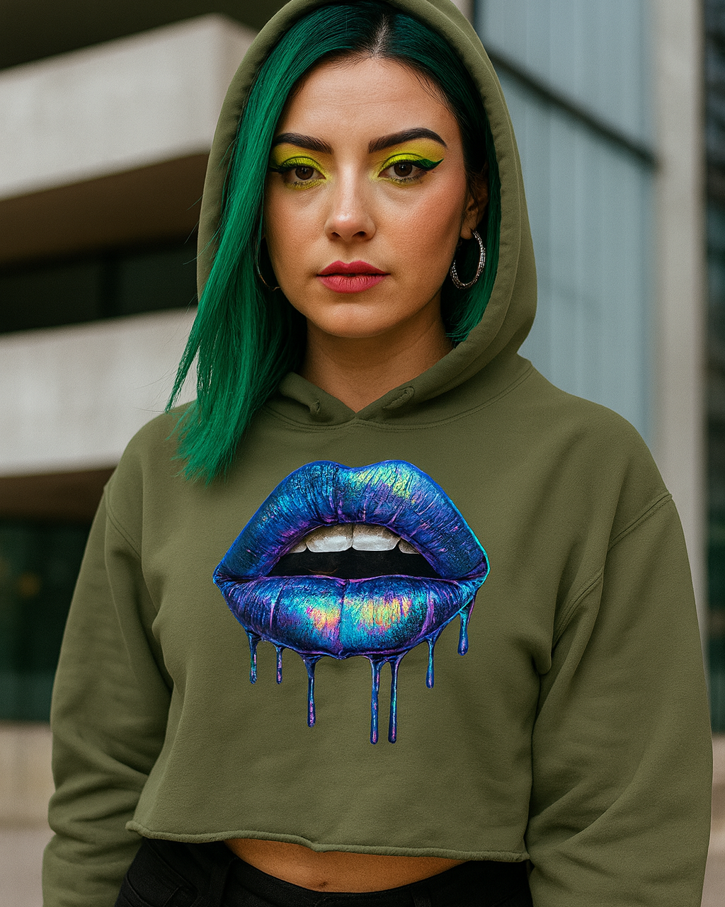 Person wearing a green crop hoodie with a colorful lip design in an urban setting