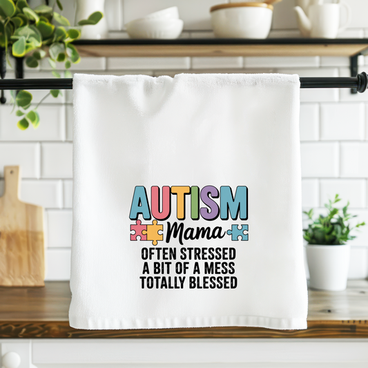 White towel with 'Autism Mama' text in a kitchen setting