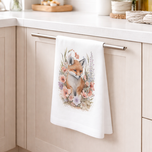 Kitchen towel with fox design hanging on a kitchen cabinet handle.