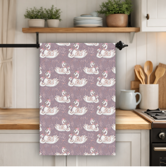 Kitchen towel with swan pattern hanging on a kitchen towel rack.