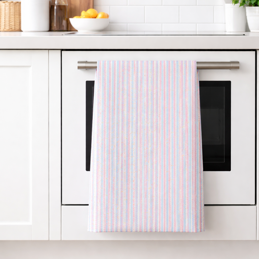 Kitchen with white cabinets, a towel hanging on an oven door, and a bowl of fruit on the counter.