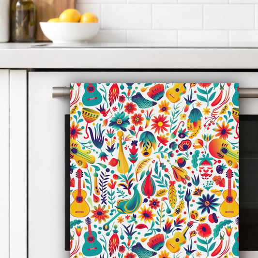 Colorful patterned towel hanging on a kitchen rack with a white tiled wall and bowl of lemons in the background.