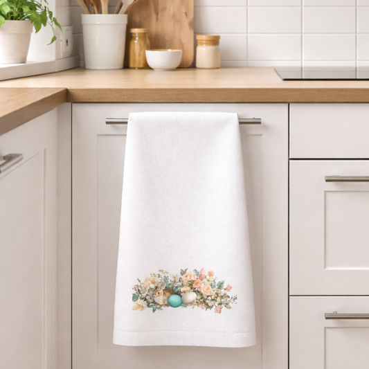 Kitchen towel with floral design hanging on a kitchen cabinet