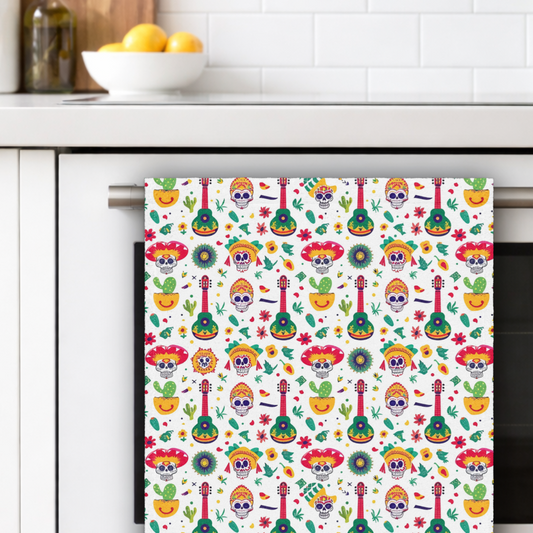 Colorful patterned towel hanging on a kitchen towel rack with a white tiled wall and bowl of lemons in the background.