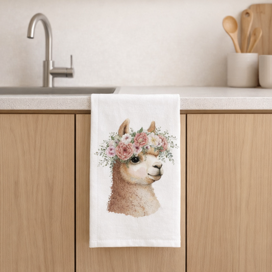 Kitchen towel with llama design hanging on a wooden cabinet