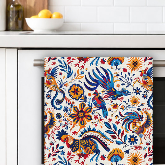 Colorful patterned towel with rooster design hanging on a kitchen cabinet.