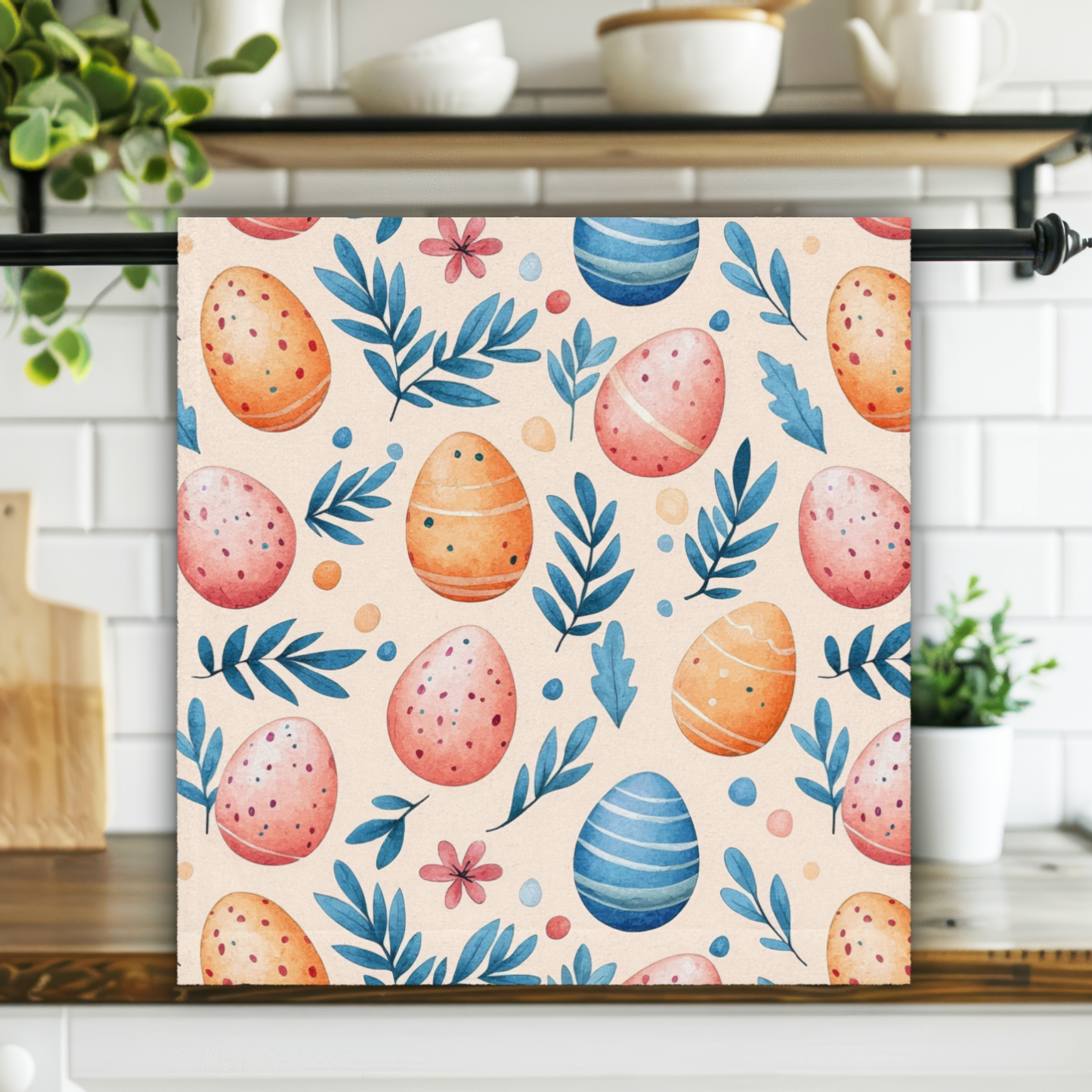 Decorative towel with Easter egg and leaf pattern hanging on a kitchen rack.