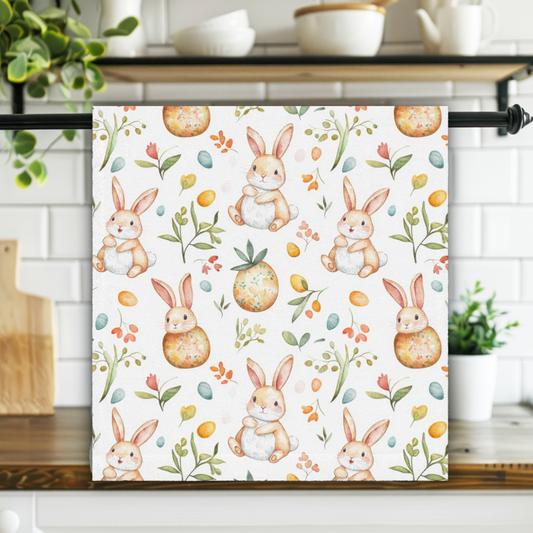 Kitchen towel with bunny and Easter egg pattern hanging on a rack in a kitchen.