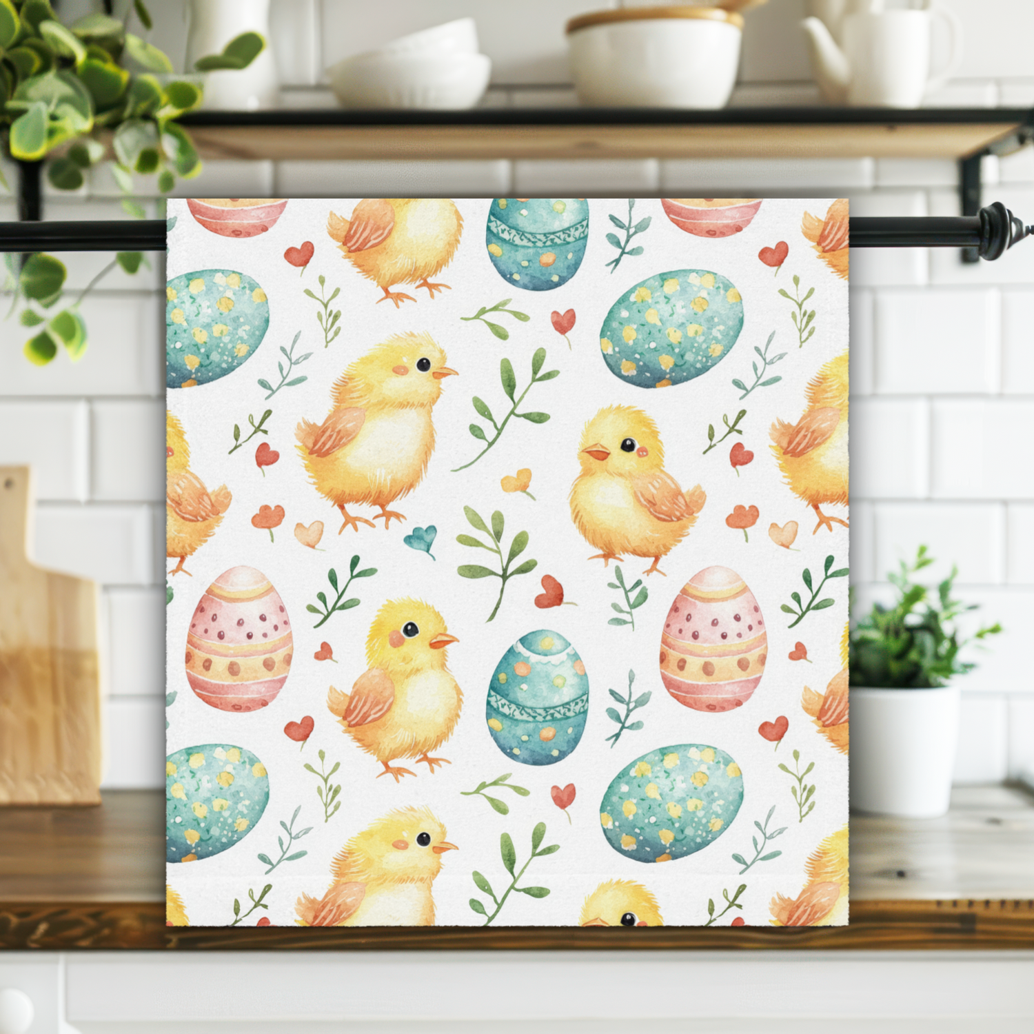 Towel with Easter design featuring chicks and eggs on a kitchen towel rack.