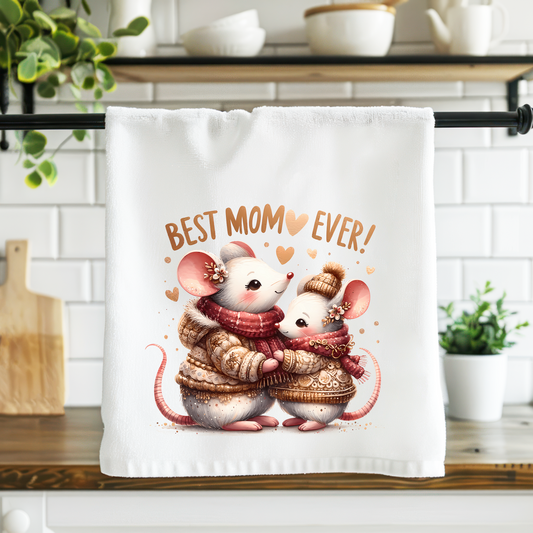 Towel with cartoon mice holding a baby mouse and 'Best Mom Ever!' text in a kitchen setting.