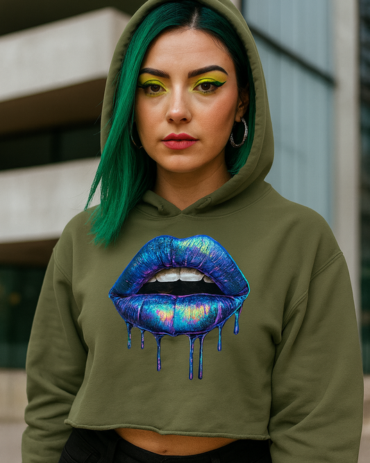 Person wearing a green crop hoodie with a colorful lip design in an urban setting