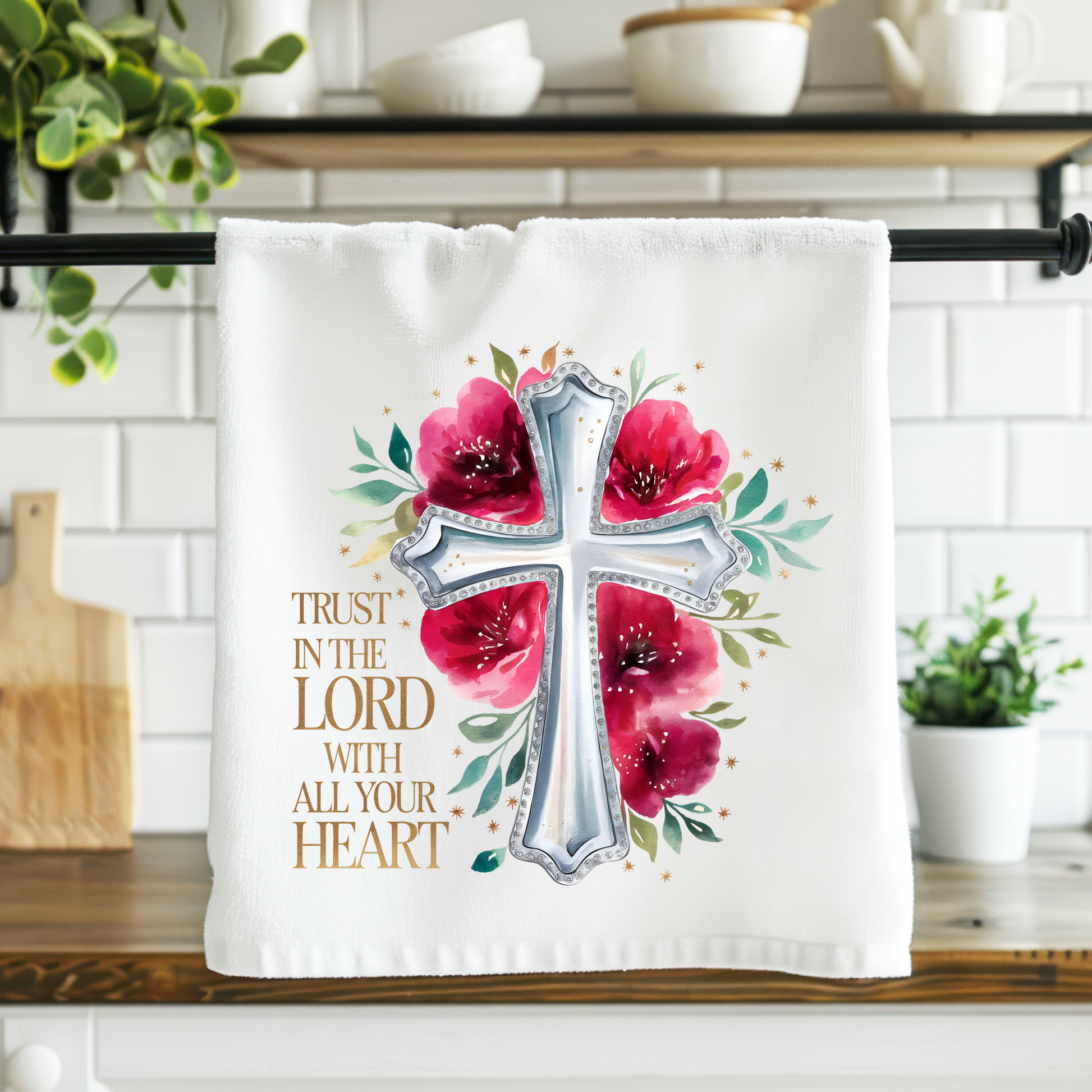 Kitchen towel with floral cross design and text on a kitchen counter.