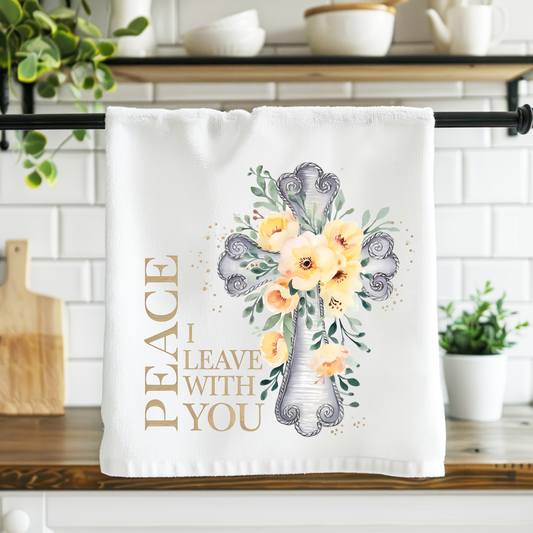 Decorative towel with floral design and text in a kitchen setting