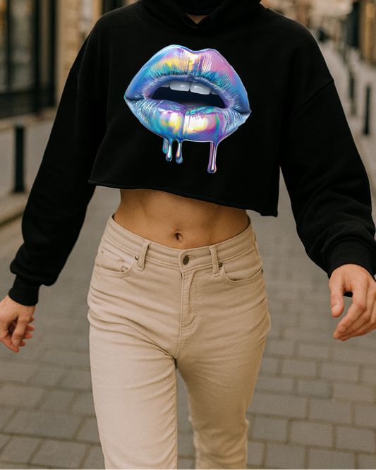 Person wearing a black hoodie with a colorful lip design on a city street.