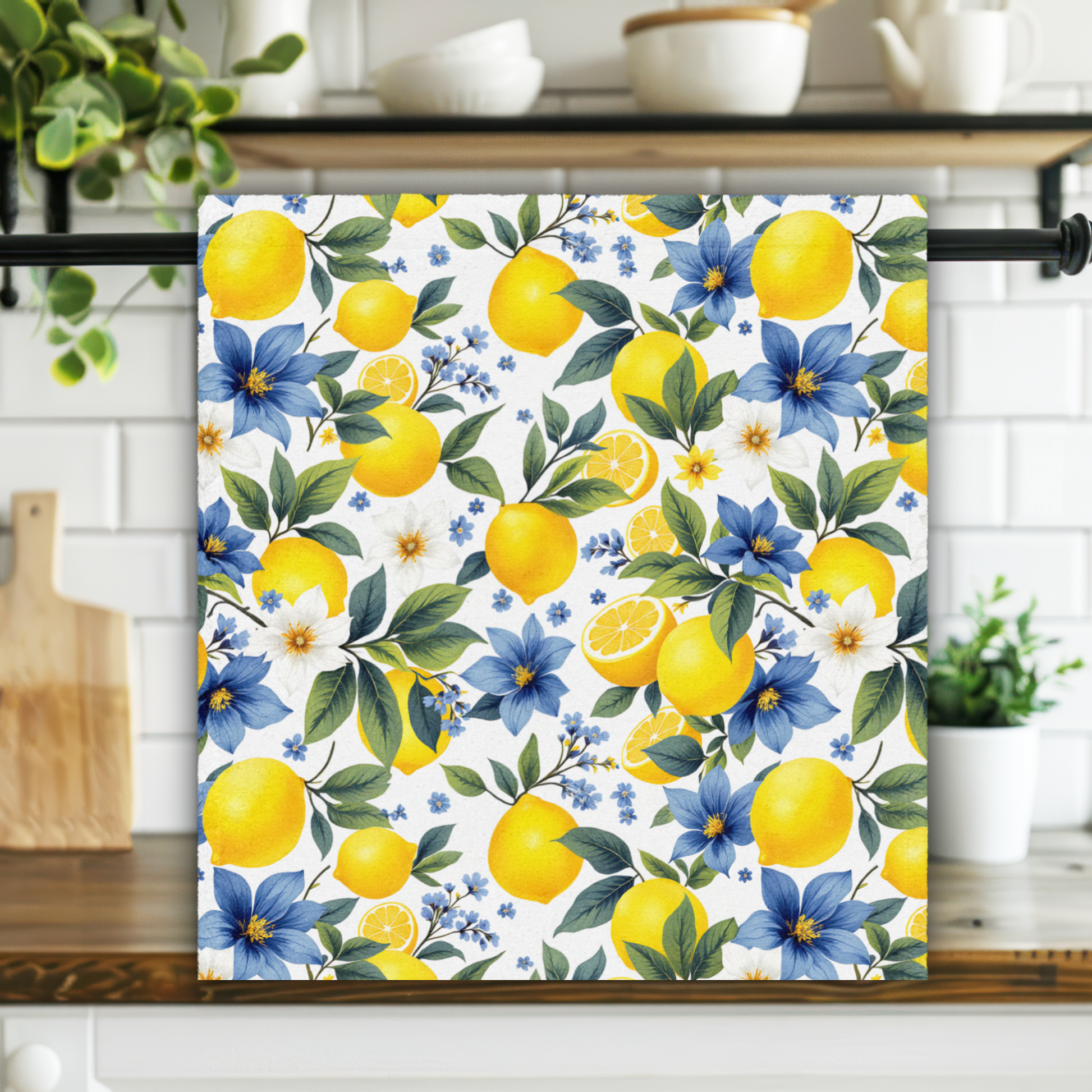 Decorative towel with lemon and floral pattern hanging on a kitchen rack.