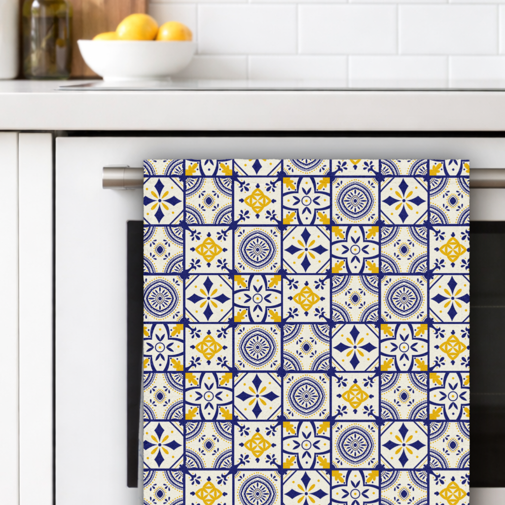 Towel with a colorful pattern hanging on a kitchen towel rack.