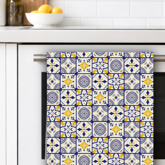 Towel with a colorful pattern hanging on a kitchen towel rack.