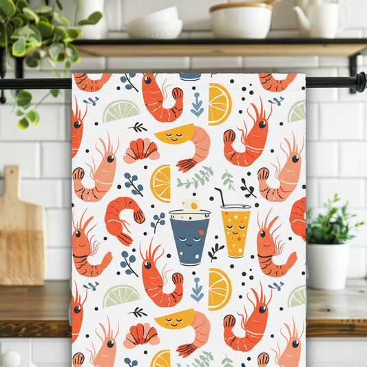 Kitchen towel with shrimp and cocktail pattern hanging on a rack in a kitchen.